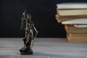 A Lady Justice statue on a car accident injury lawyer's desk.