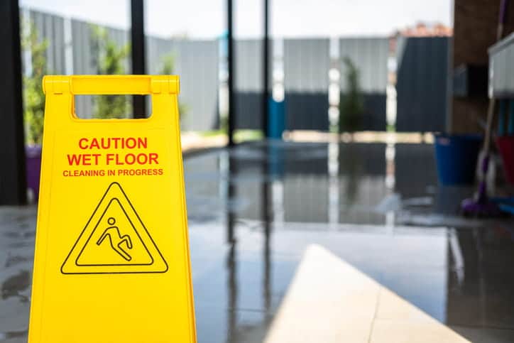 A yellow caution: wet floor sign that says, "Cleaning in Progress."
