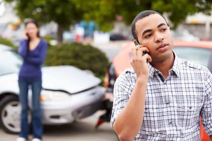 Two people on the phone with their car accident lawyers after being in a car accident. 